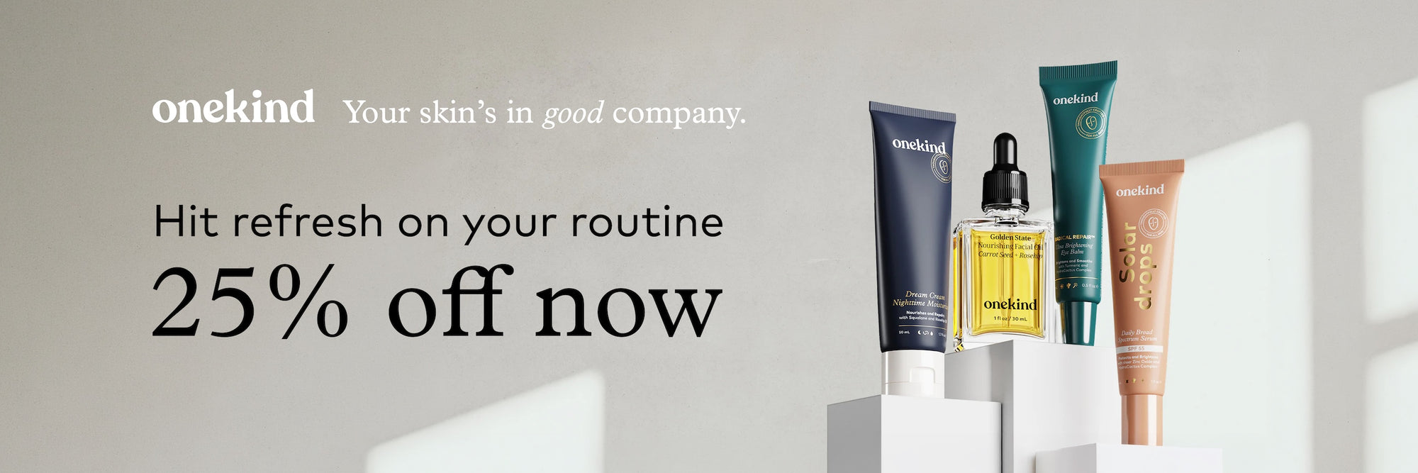 OneKind skincare products with promotional text on a light gray background